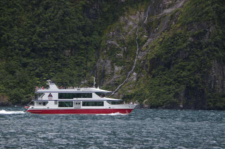 A tourist boat in Milford Sound, New zealandのeditorial素材