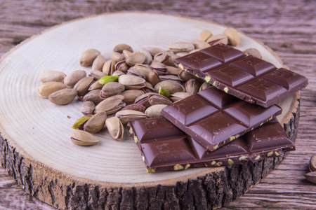 Chocolate and Pistachio nuts on the wood table, wood backgroundの写真素材