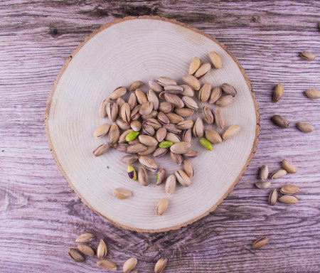 Pistachio nuts on the wood table and wood backgroundの写真素材