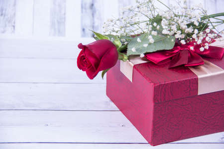 rose flower and gift box on wooden backgroundの写真素材