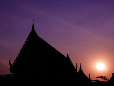 Silhouette temple roof with sunset backgroundの写真素材
