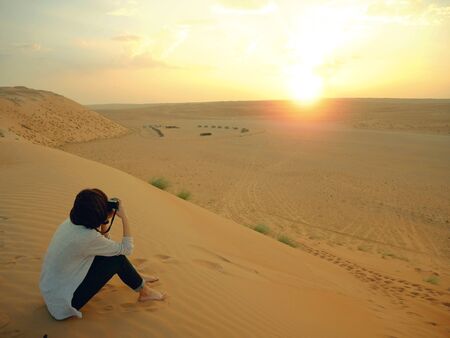 Taking photo of sunset in Wahiba desert, Omanの写真素材