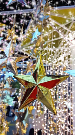 Selective focus gold and silver star decorations with sparkle trailsの写真素材