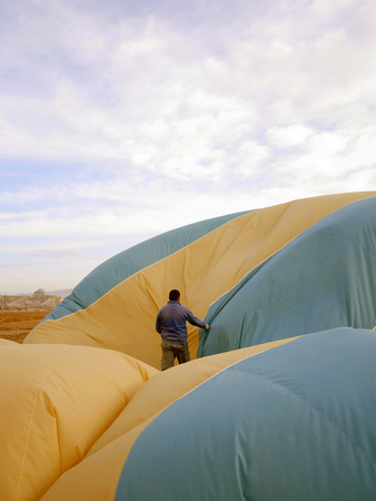 Staff collecting a hot air balloon after flight at Cappadocia, Turkeyの写真素材