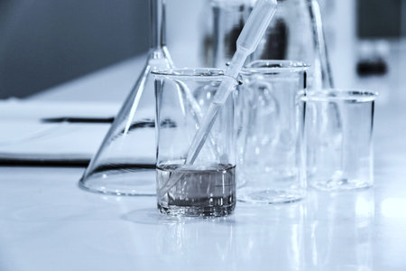 Laboratory glassware and test tubes on table, closeup of photo