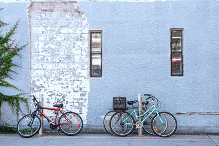 Bicycles parked in front of a blue wall in the cityの写真素材