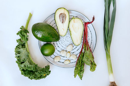Avocado, spinach, garlic and leek on a white background