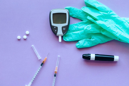 Glucose meter, syringe, blood test and gloves on purple background