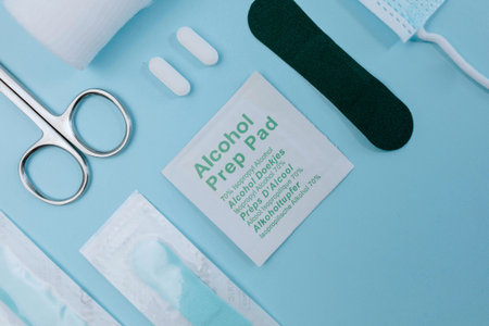Top view of medical equipment on blue background. First aid kit.