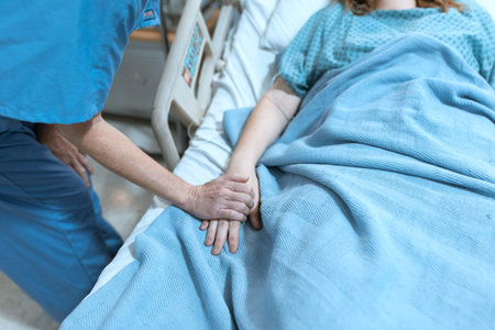 Physiotherapist examining a patient's arm in a hospital.
