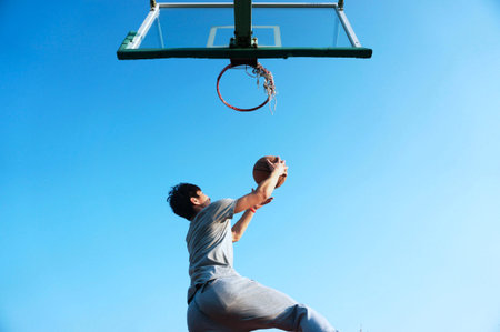 basketball player practicing and posing for basketball and sports athlete concept isolated on blue...