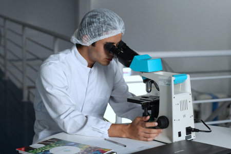 scientist working with microscope in laboratory, science research and development concept