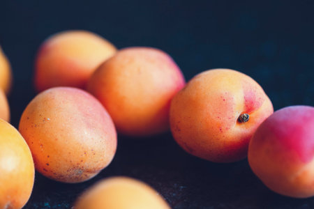 Ripe apricots on a dark background, selective focus.