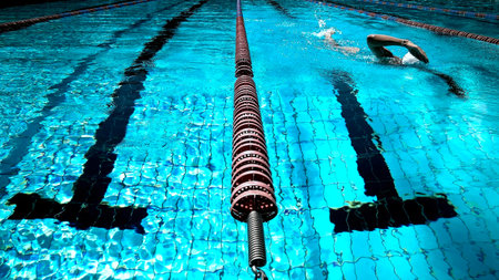 Swimming pool with a person swimming in background