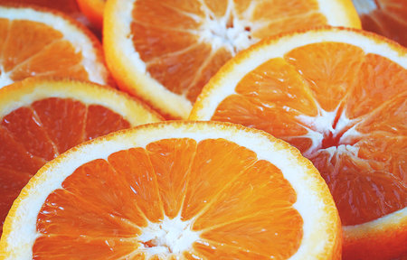 Slices of fresh orange on a white background. Close-up.
