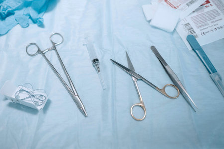 Surgical instruments and tools on a table in an operating room.