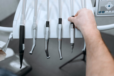 Close-up of a dentist's hand holding dental tools in a dental clinic
