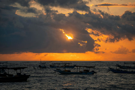 Fishing boats on the sea at sunset. Beautiful dramatic sky.の写真素材