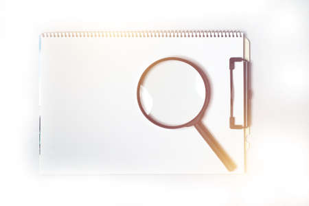 magnifying glass on note bookの写真素材
