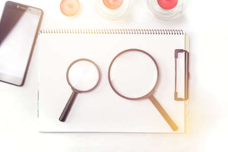 magnifying glass on note bookの写真素材