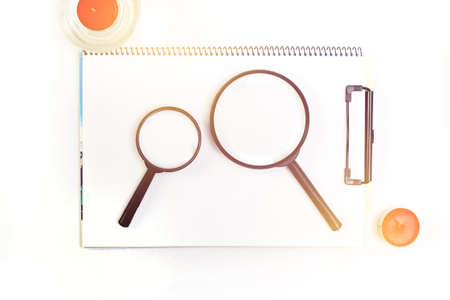 magnifying glass on note bookの写真素材