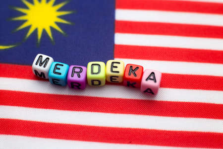 Malaysian flag with dice test wrote "hari merdeka"の写真素材