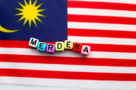 Malaysian flag with dice test wrote "hari merdeka"の写真素材