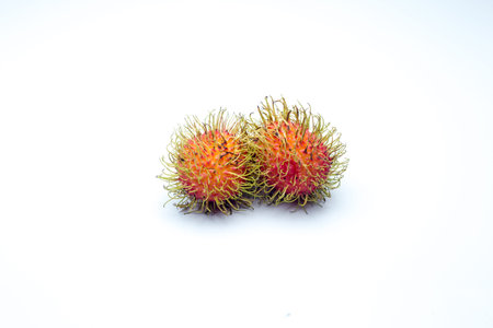 tropical friut called rambutan on white backgroundの写真素材