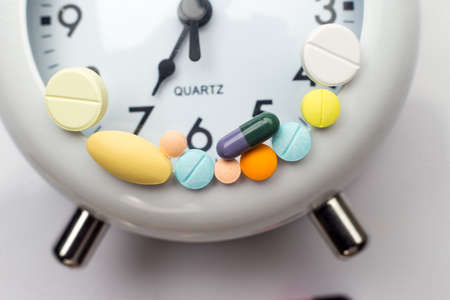 pills and tablet medicine on clockの写真素材