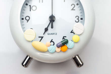 pills and tablet medicine on clockの写真素材