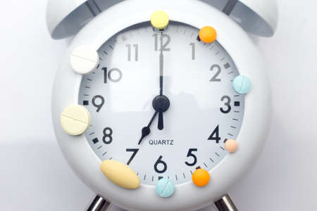 pills and tablet medicine on clockの写真素材