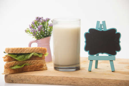 Sandwich and glass of fresh milk, blackboardの写真素材