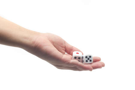hand holding dice on white isolated background, selective focusの写真素材