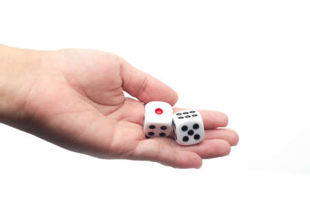 hand holding dice on white isolated background, selective focusの写真素材