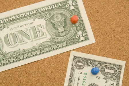 One dollar bills on a cork board with copy space. Money concept の写真素材