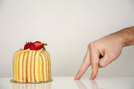 Fingers walking towards cakeの写真素材