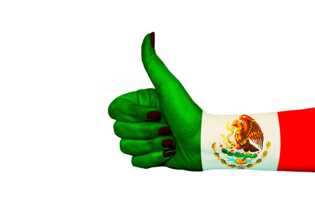 Mexico flag painted on hand showing thumbs upの写真素材