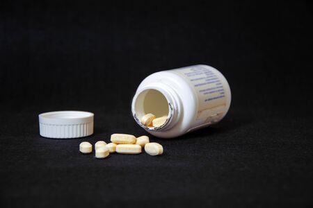 pile of pills on black backgroundの写真素材