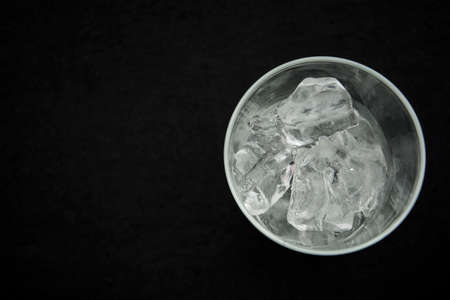 Top view of glass full of ice against black backgroundの写真素材