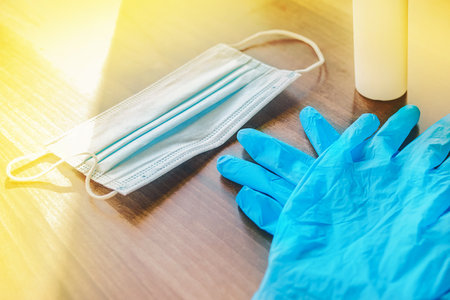 Protective latex gloves and a medical mask on the table background.の写真素材