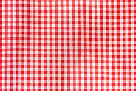 Red and white abstract checkered background, gingham picnic tablecloth, fabric pattern texture.