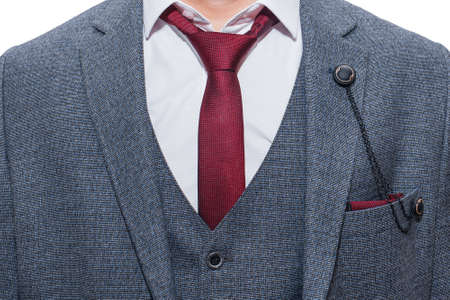 Men's dark gray suit with white shirt and red tie.の写真素材