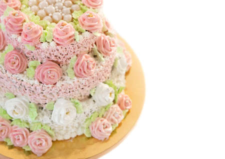 Wedding white cake decorated with colored cream flowers roses and edible pearls.の写真素材