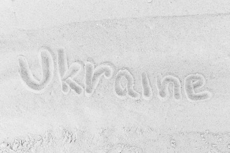 The word Ukrainian sign or symbol written on white beach sand close-up.の写真素材