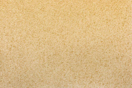 Sand plaster texture stucco wall yellow surface background.の写真素材