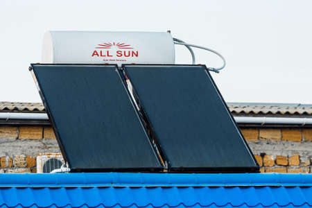 Ukraine, Iron Port - August 22, 2020: Solar water heater against the background of the sky. Using solar energy to heat water.のeditorial素材
