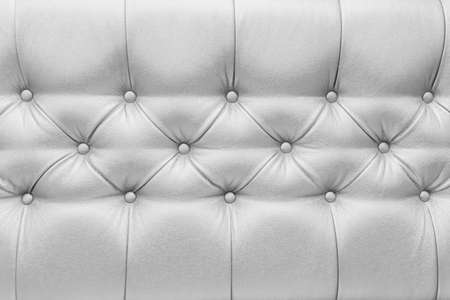 Light gray or white leather upholstery sofa with pattern button design furniture style decor texture background.の写真素材