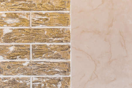 Dark yellow brick wall with abstract pattern and beige tile texture modern building facade background.の写真素材