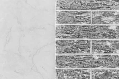 Gray brick wall with abstract pattern and light white tile texture modern building facade background.の写真素材