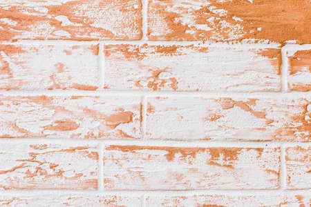 Light white brick wall with orange decorative paint patterns texture background.の写真素材